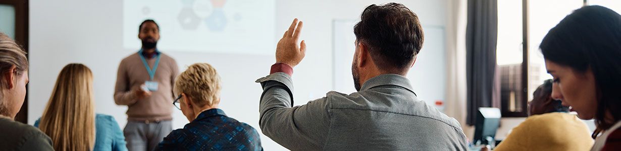 A group of people in a classroom learning about health and safety training