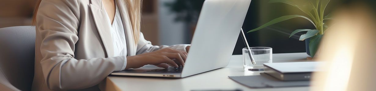 A person looking at a laptop and researching different courses and qualifications